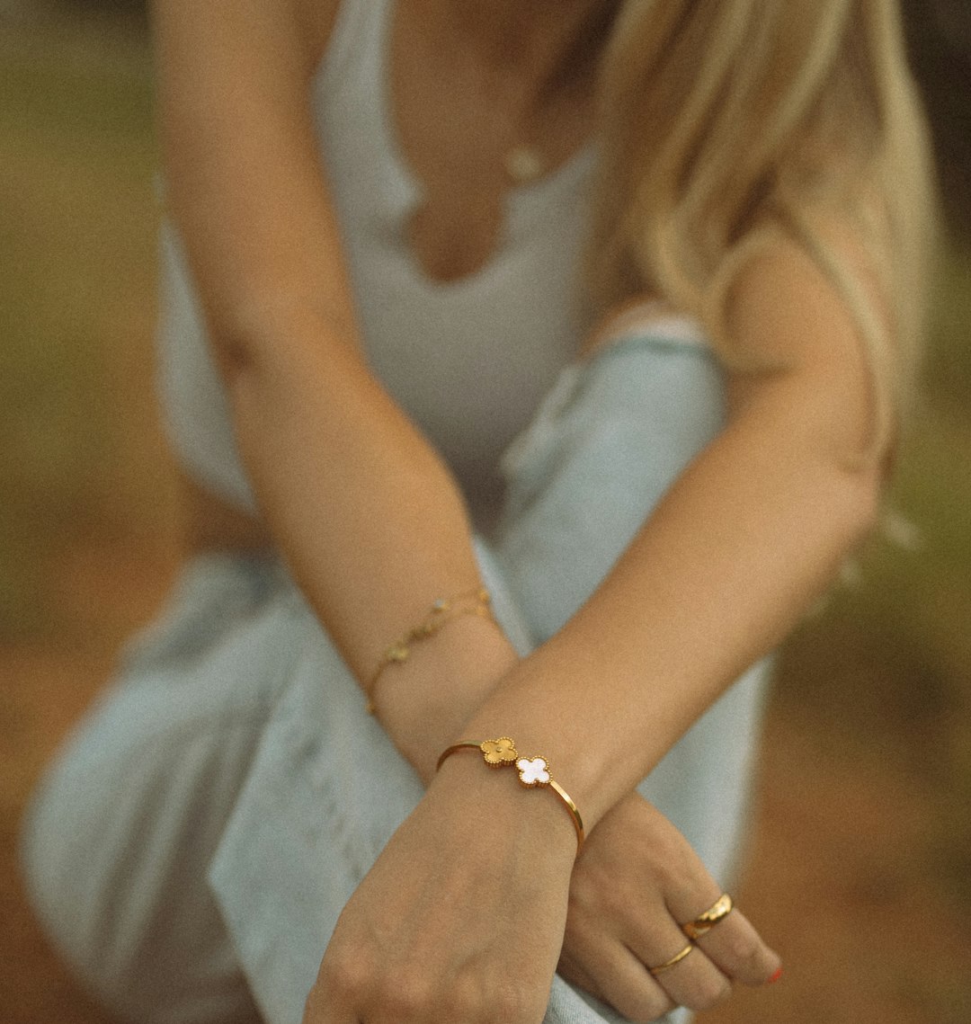 Gold bracelets and rings styled with white shirt