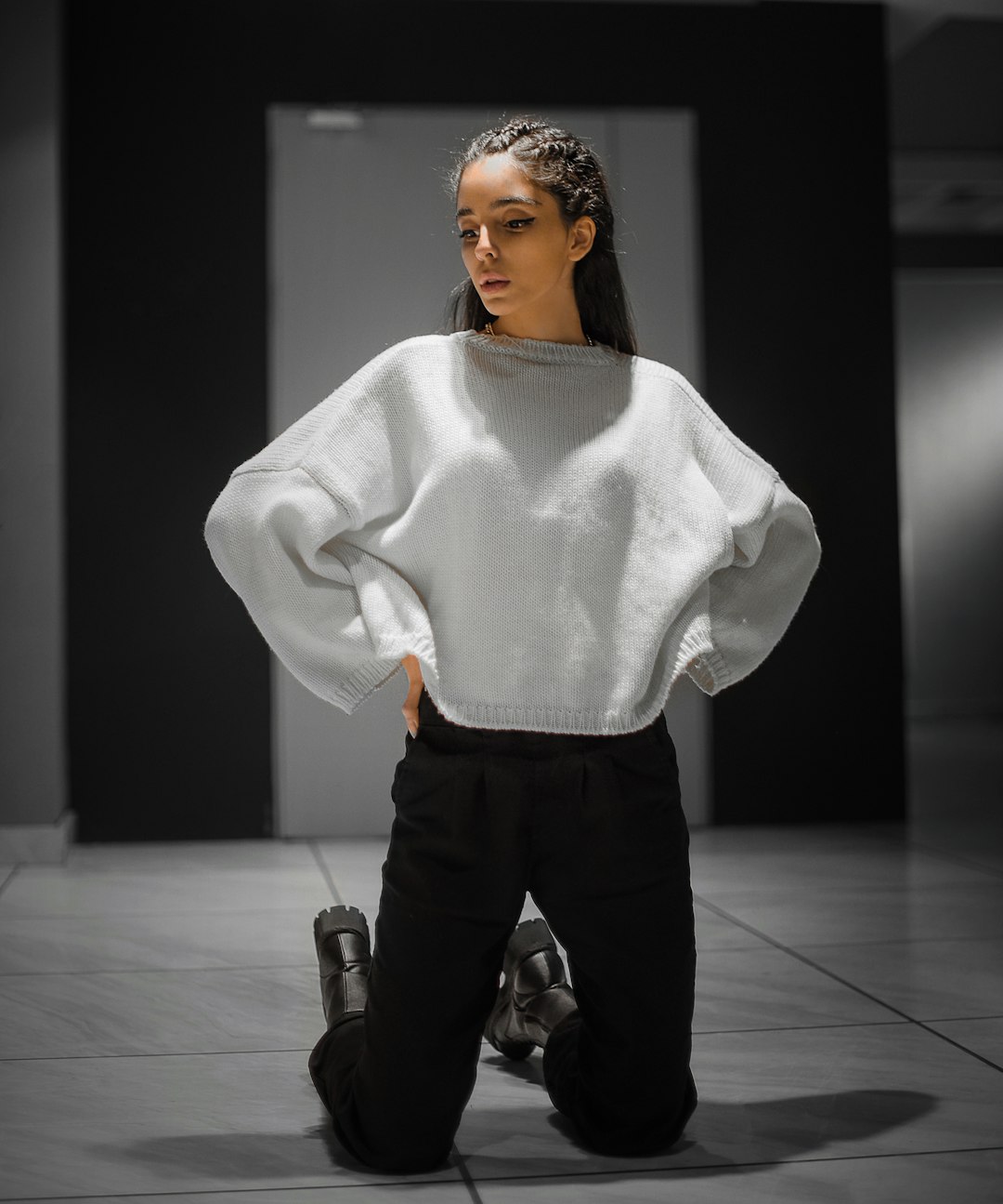 Model in wide-leg trousers and cream knit sweater